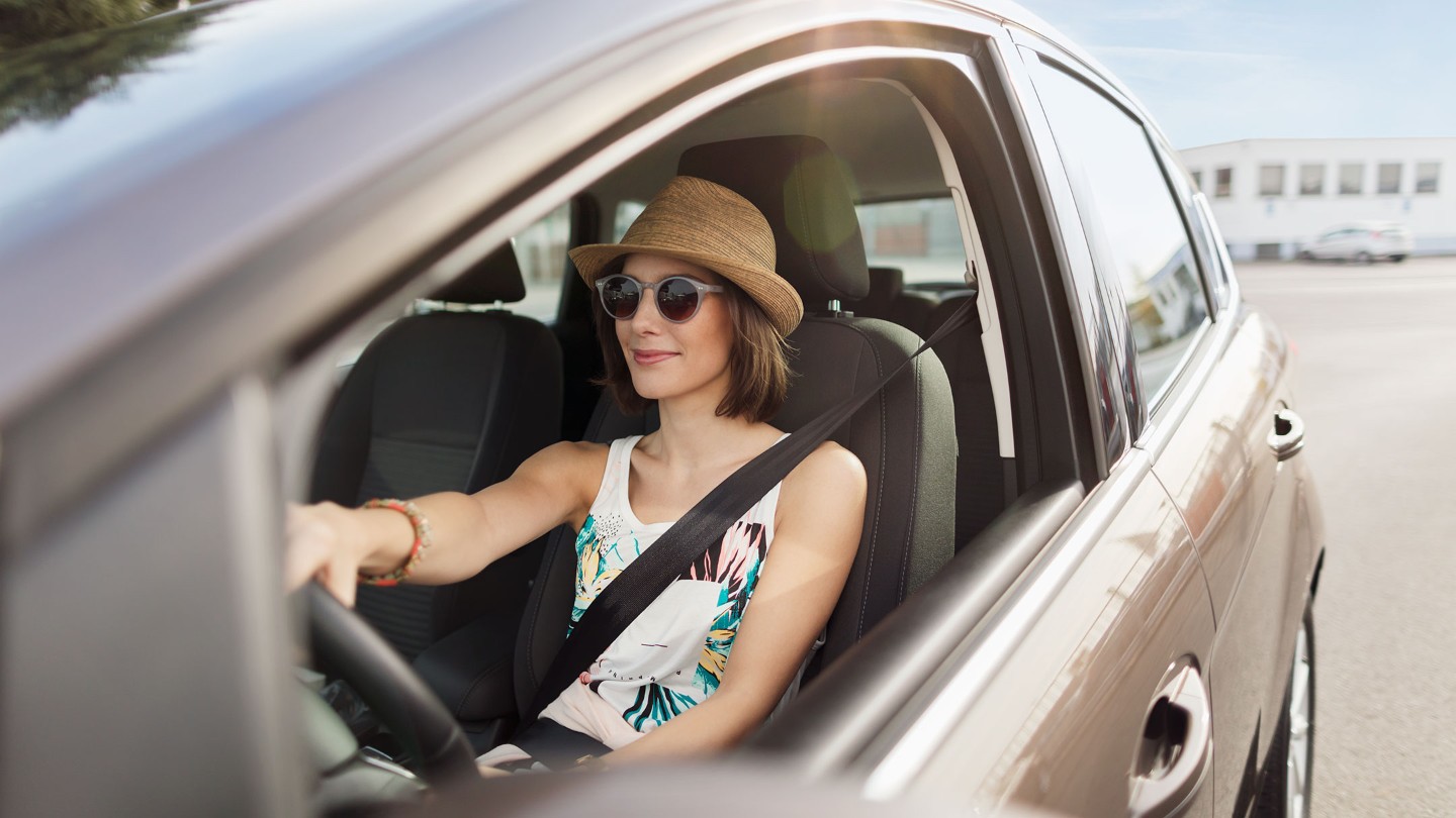 Woman driving grey Ford