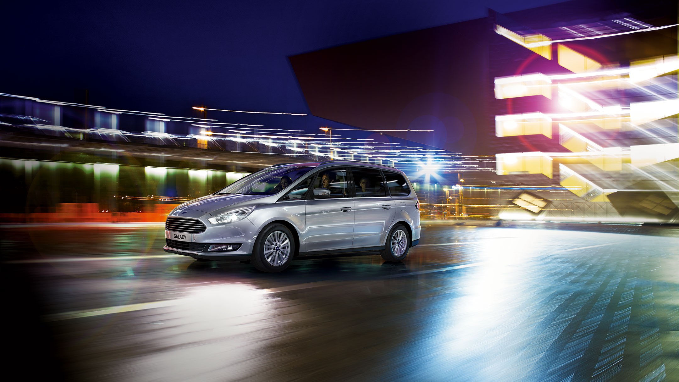Ford driving in the city at night