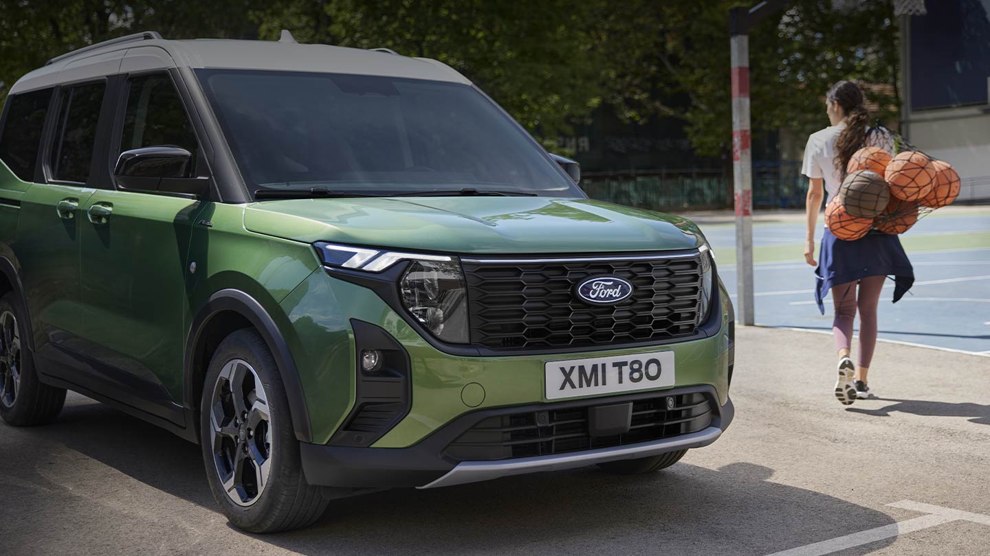 A rear view of Ford Explorer® driving through a forest