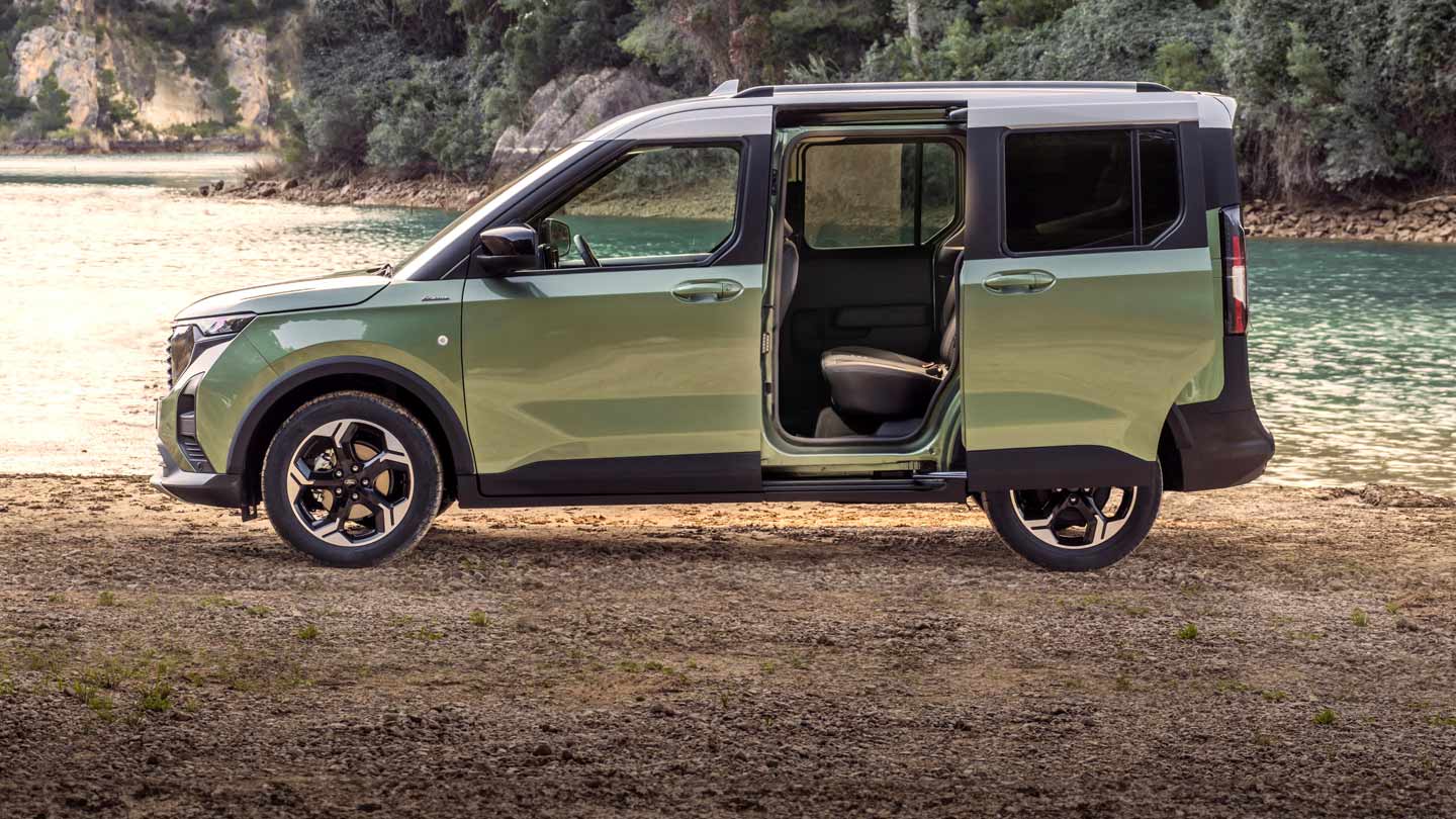 Green Tourneo Courier parked by a lake with rear doors open