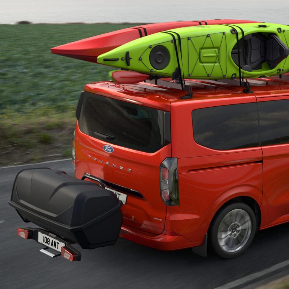 Red Tourneo Custom with boats on the roof and a storage accessory