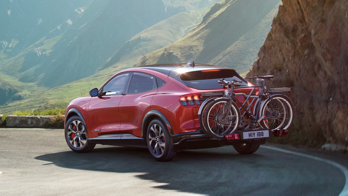 Mustang Mach-E driving with bicycles attached to the rear