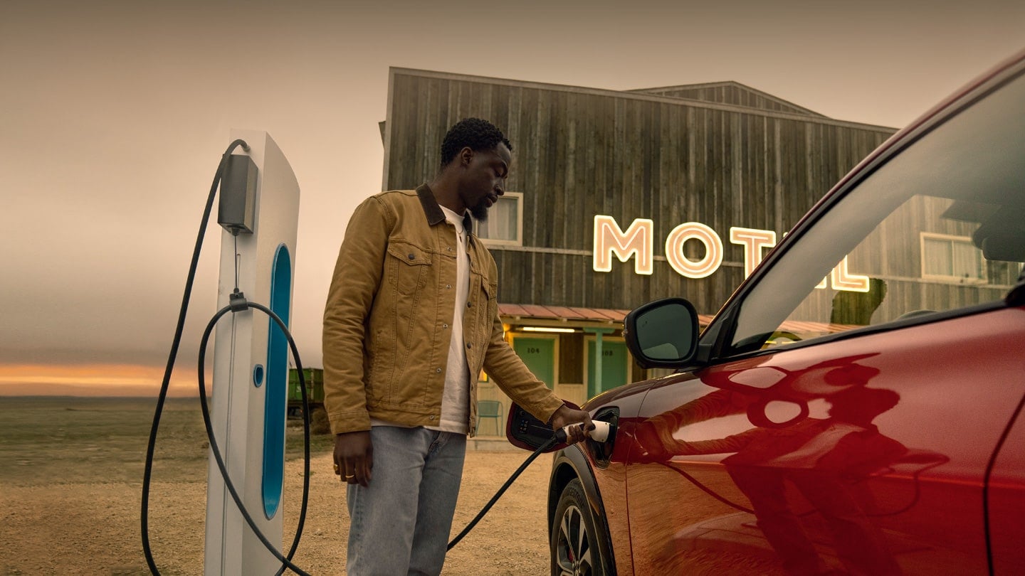 A person charging Ford Mustang Mach-E