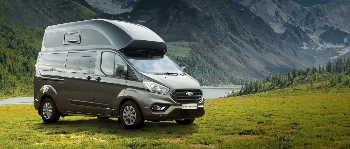 New Transit Custom Nugget Plus parked on grass near mountains