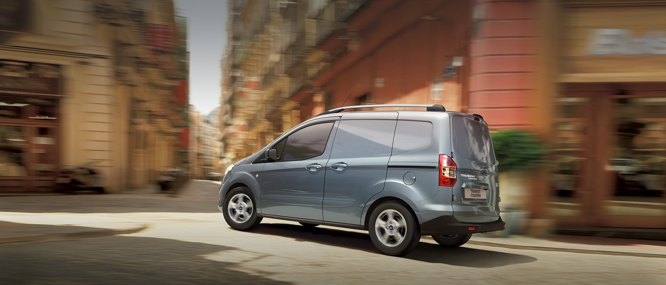 New Ford Transit Courier driving in city street