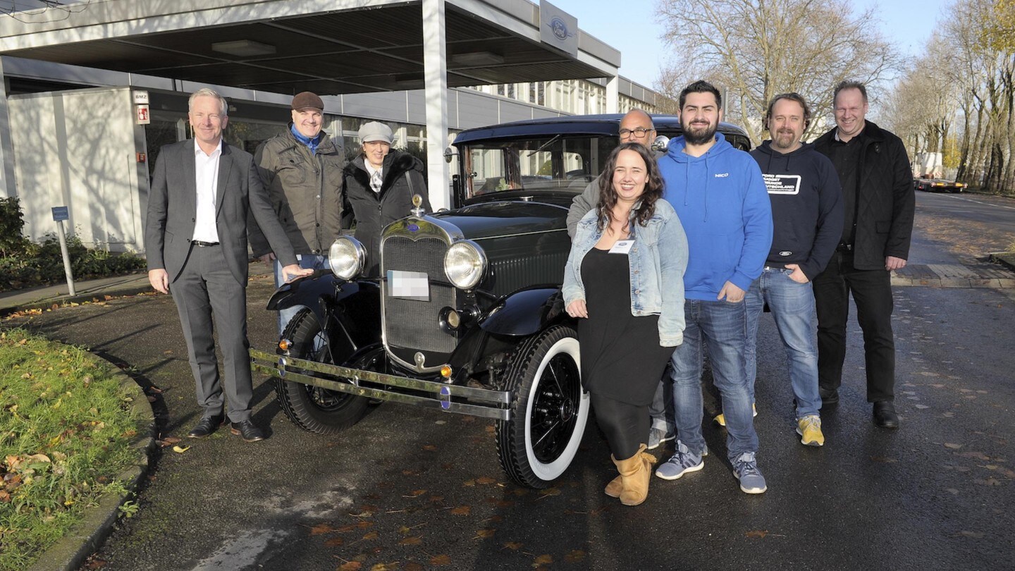 People standing around Ford veteran