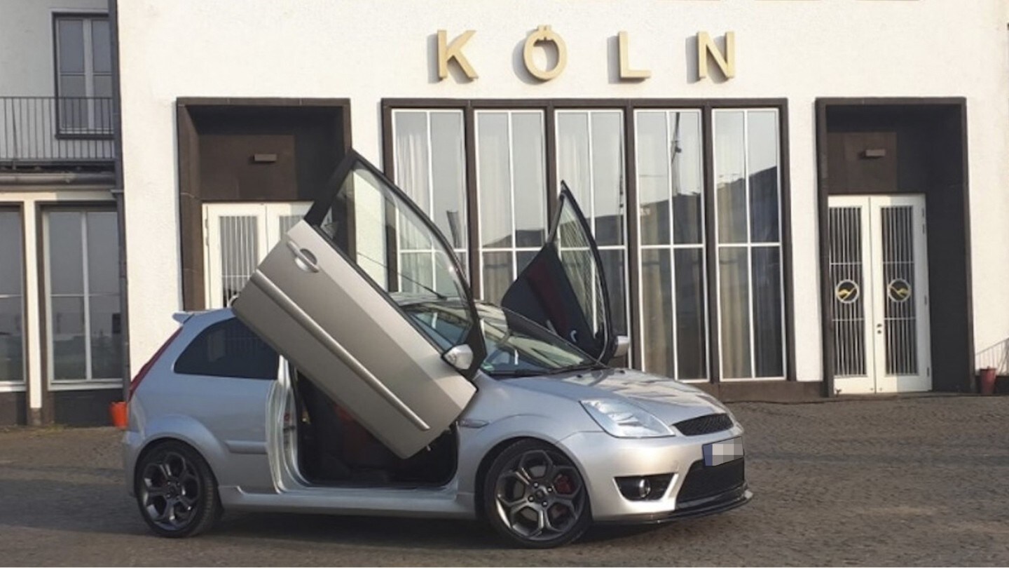 Ford car with open door.