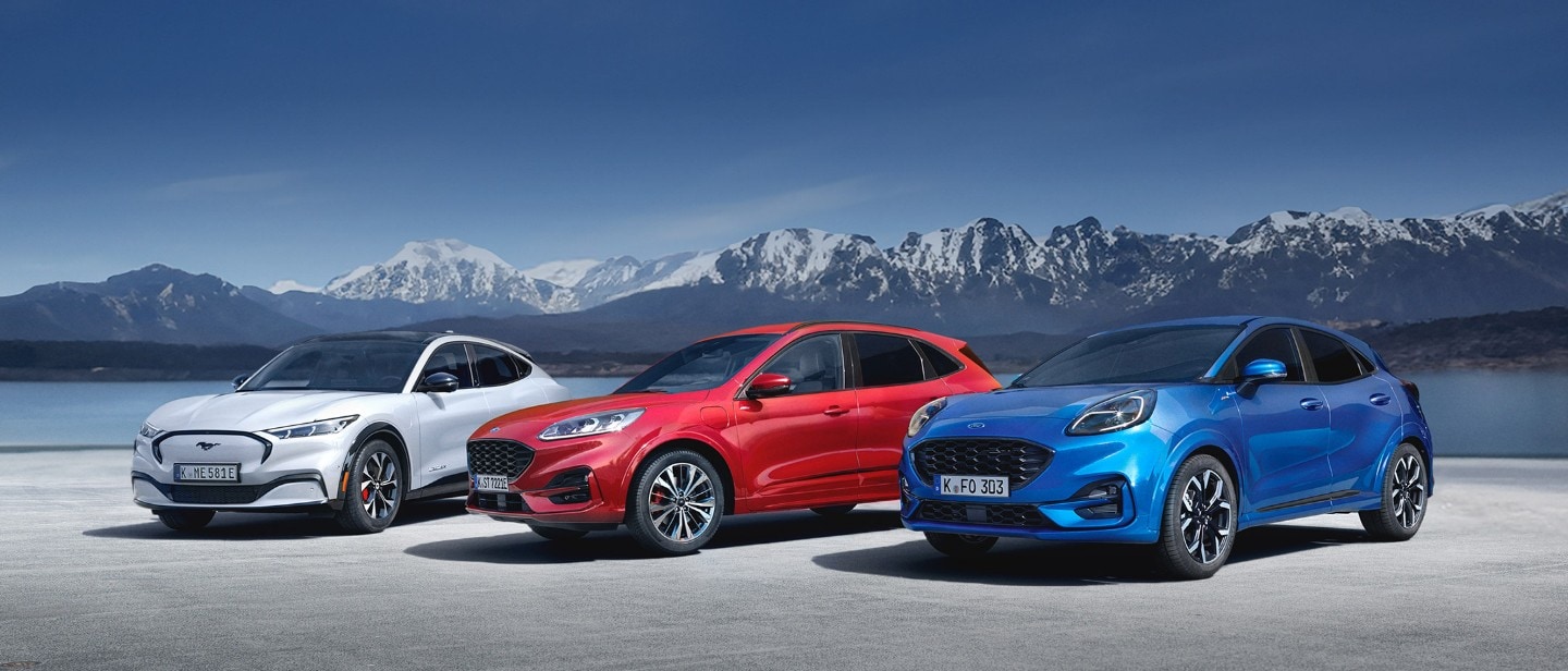 Ford Mustang Mach-E, Ford Kuga and Ford Puma parked, with mountains in the background