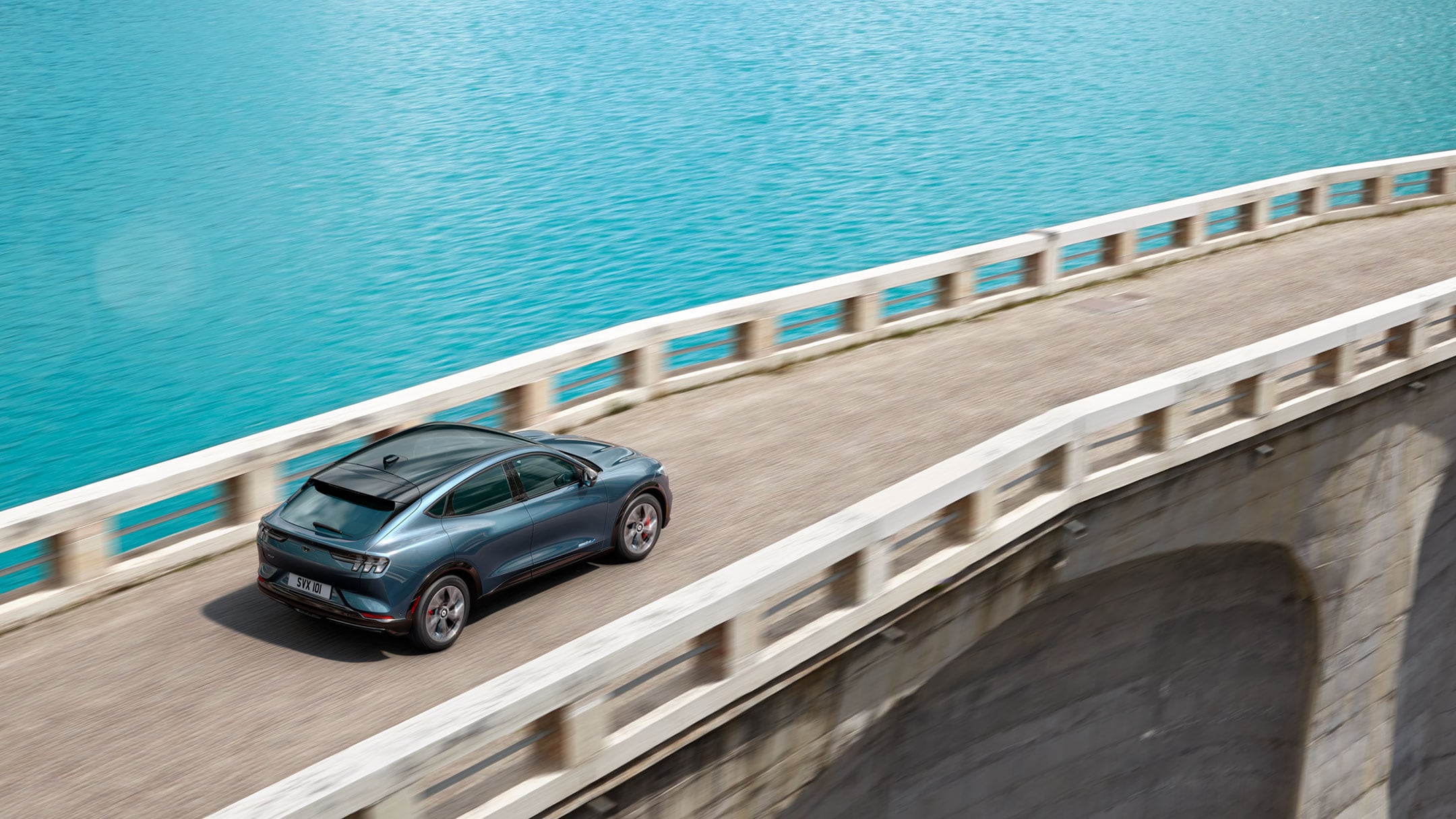 Ford Mustang Mach-E driving across a bridge