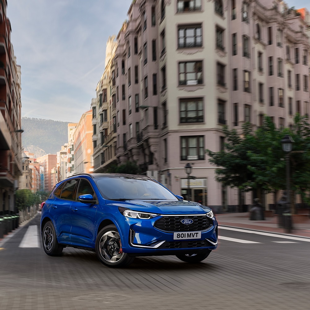 Blue All-New Ford Kuga PHEV charging at home