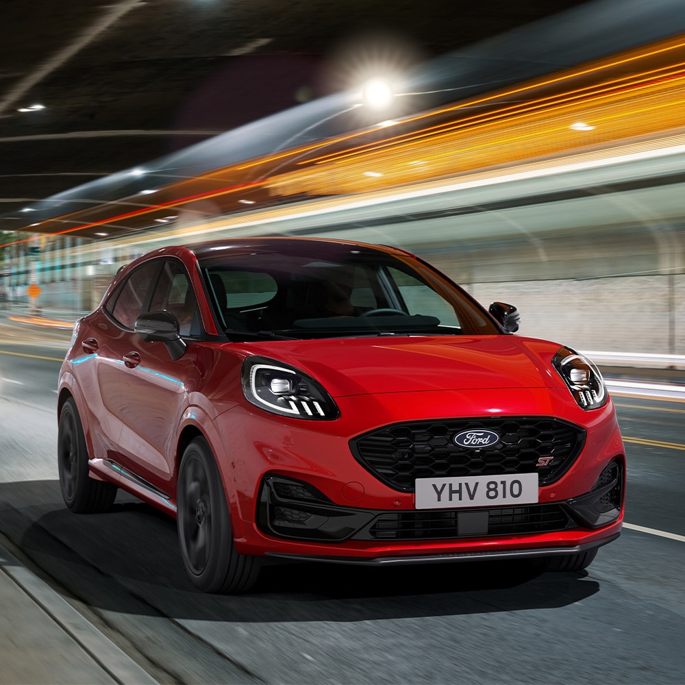 Red new Ford Puma ST driving front view
