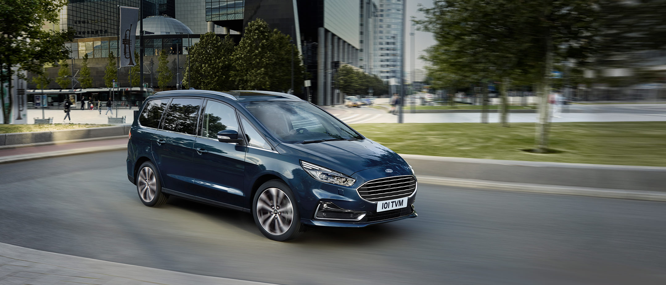 Ford Galaxy Titanium driving around the bend in city