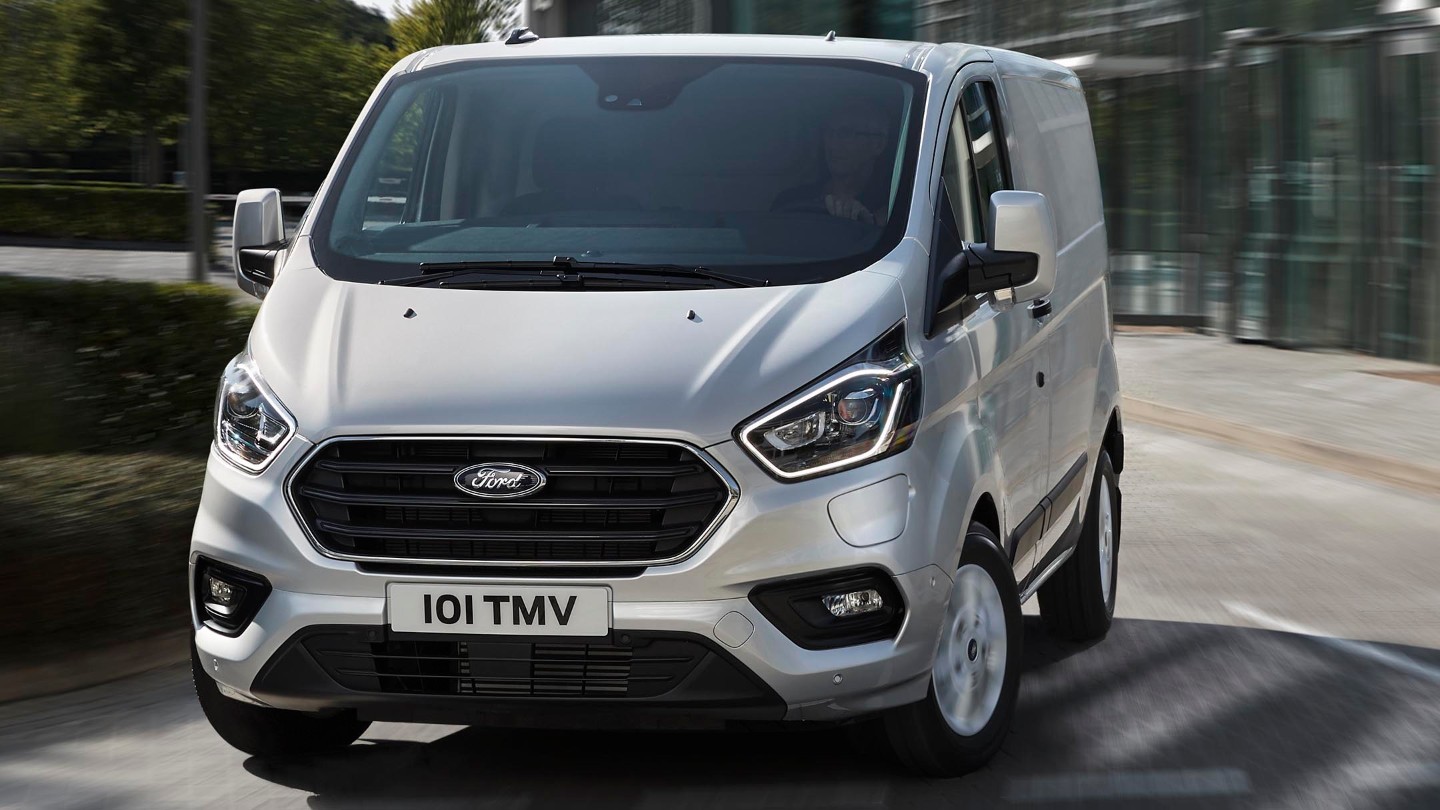 Ford Transit Custom Kastenwagen LKW Plug-in-Hybrid Silber ¾-Frontansicht in Bewegung auf Straße