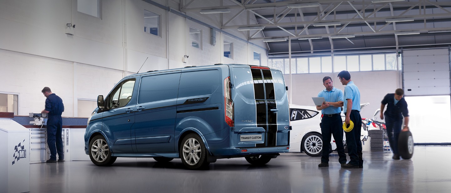 New Blue Ford Transit Custom in workshop with black sport stripe