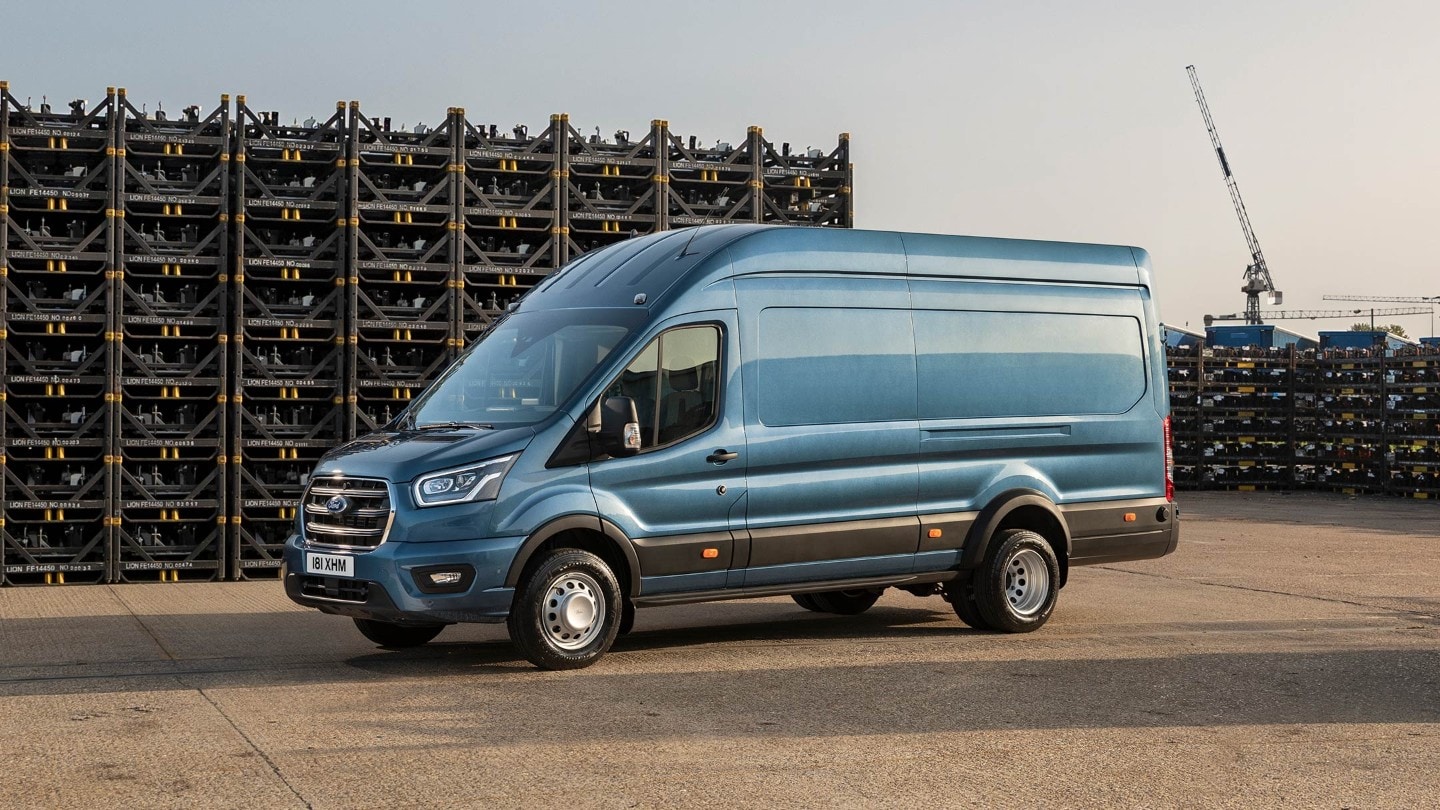 Ford Transit 5 Tonnen Kastenwagen LKW Blau Seitenansicht parkt auf Betriebsgelände vor Palettenstapeln