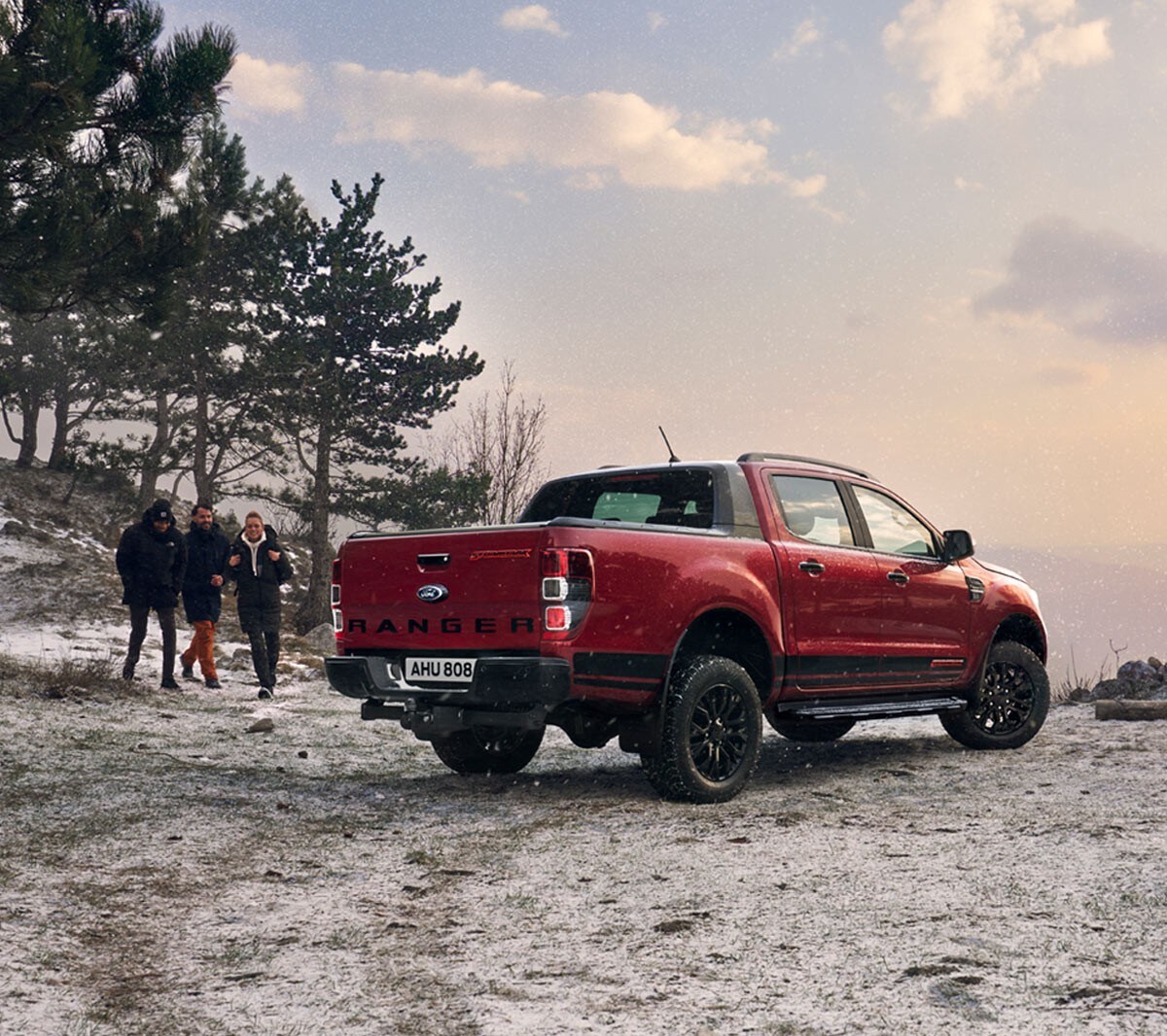 Ford Ranger Stormtrak in Rot in der ¾ Heckansicht auf schneebedecktem Feld parkend