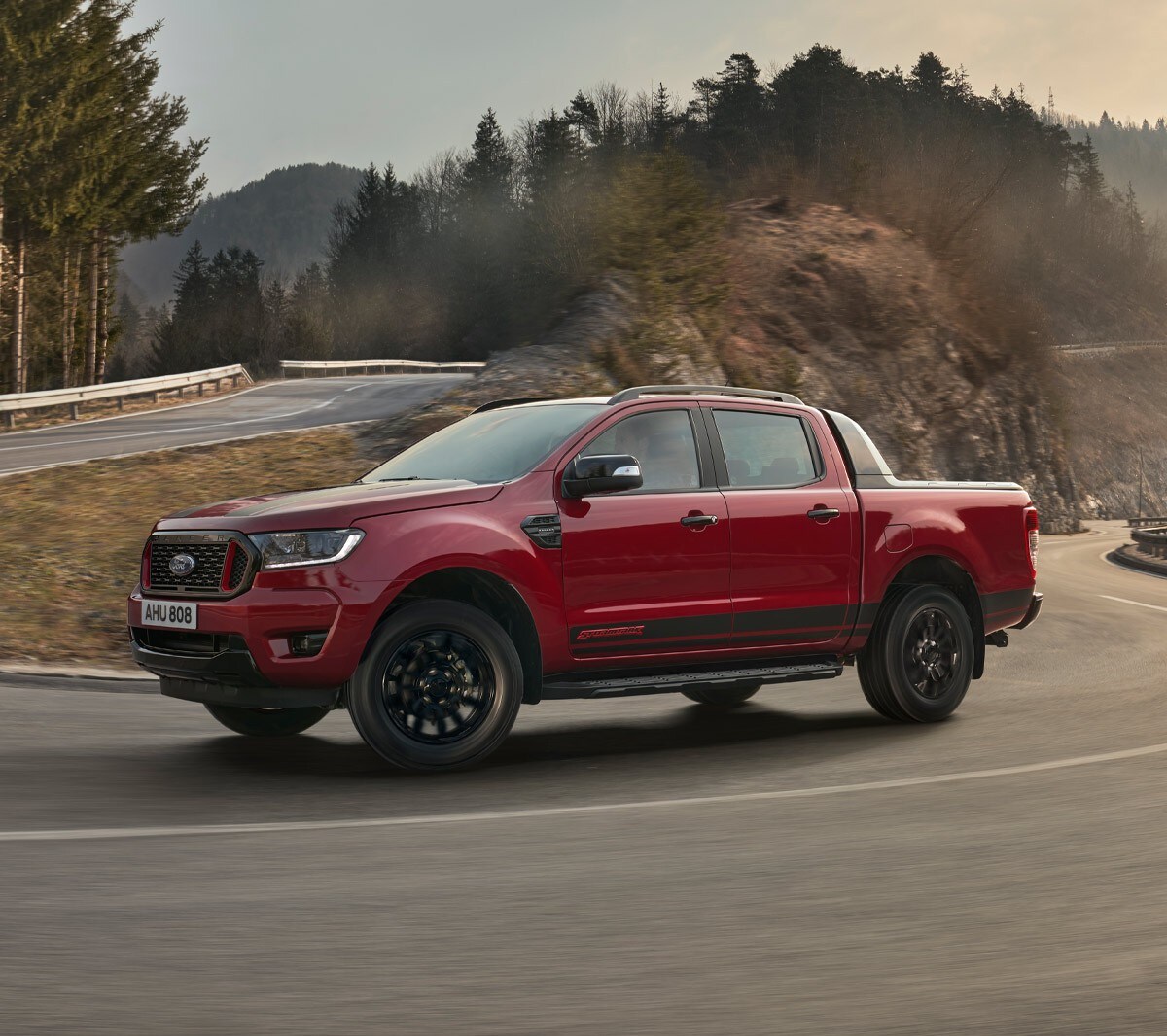 Ford Ranger Stromtrak in Rot in der Seitenansicht auf Landstraße fahrend
