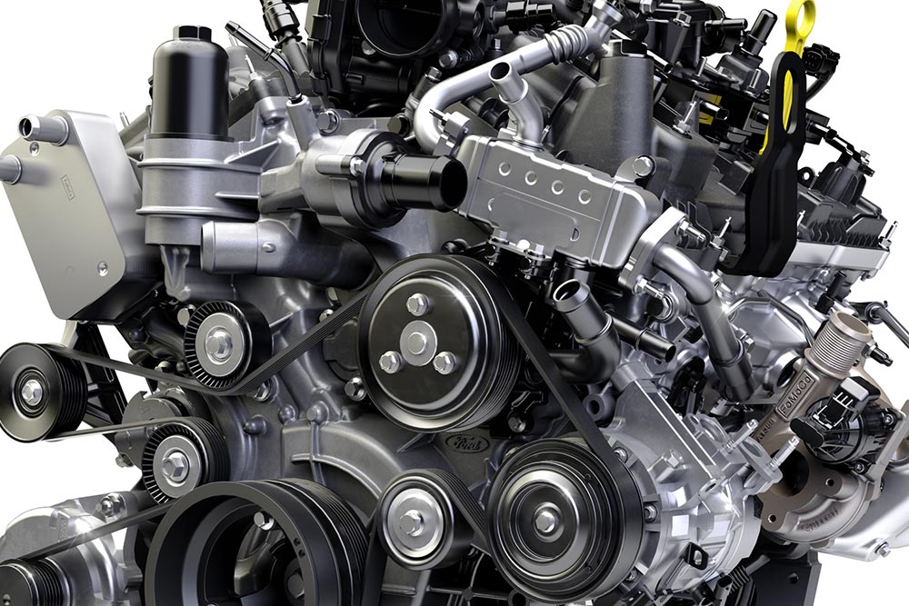 Nahaufnahme eines Fahrzeugmotors mit mehreren Riemen, Riemenscheiben und mechanischen Komponenten.
