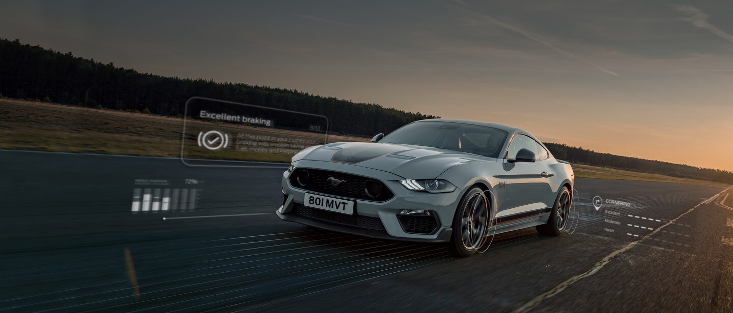 Ford Mustang in Grau fahrend auf Rennstrecke mit angezeigten Smart Features