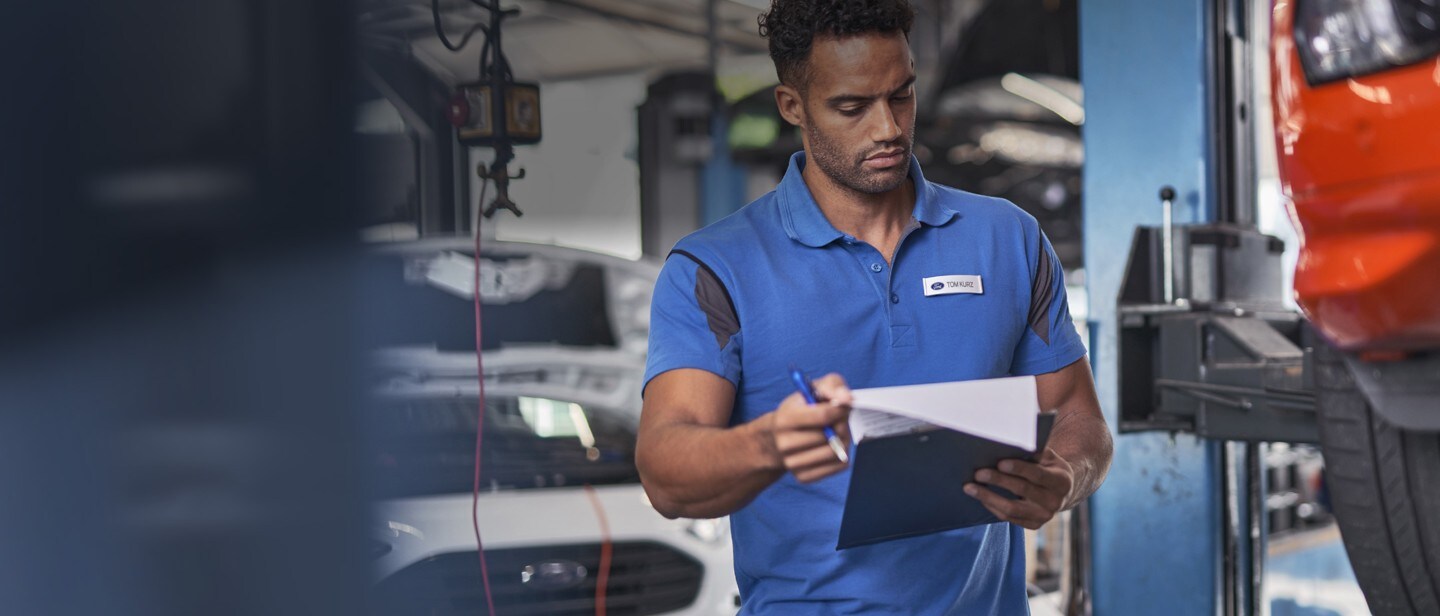 Technician inspecting vehicle 